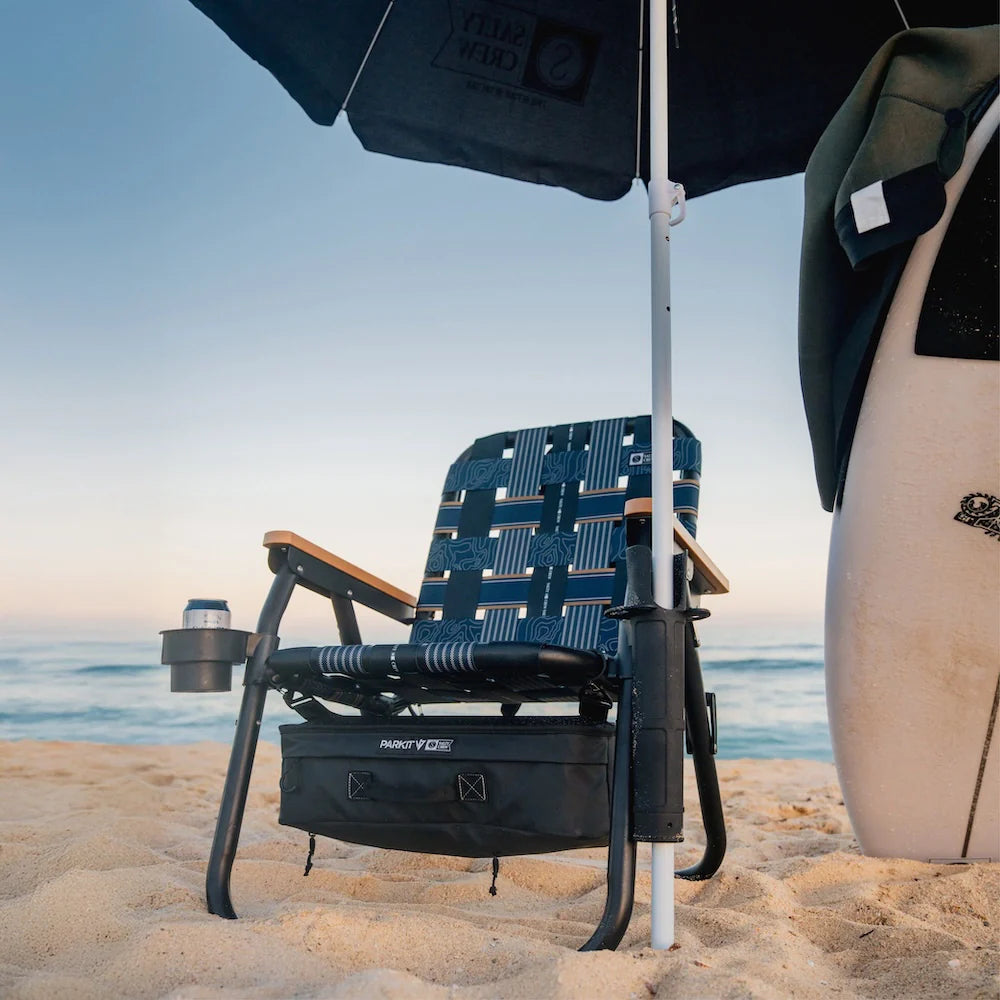 PARKIT x Salty Crew Voyager Chair in limited-edition topo-map pattern, featuring woven webbing, black steel frame, wooden armrests, built-in cooler, cup holder, and backpack straps, rugged 3-in-1 outdoor chair built for surf, fish, and adventure.