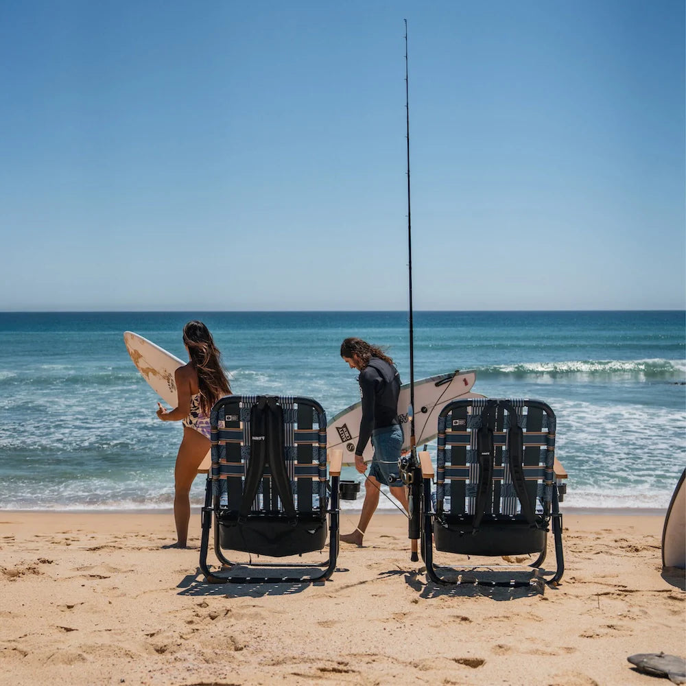 PARKIT x Salty Crew Voyager Chair in limited-edition topo-map pattern, featuring woven webbing, black steel frame, wooden armrests, built-in cooler, cup holder, and backpack straps, rugged 3-in-1 outdoor chair built for surf, fish, and adventure.