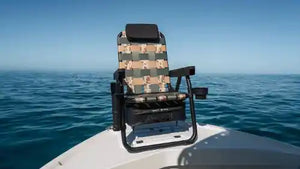 Fishing chair with camouflage pattern on a boat in the middle of a body of water